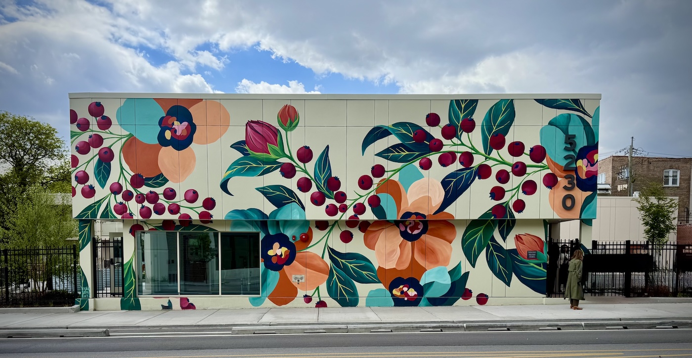 white building with a colorful floral mural