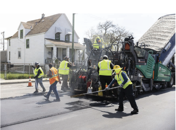 Construction workers repaving a city street